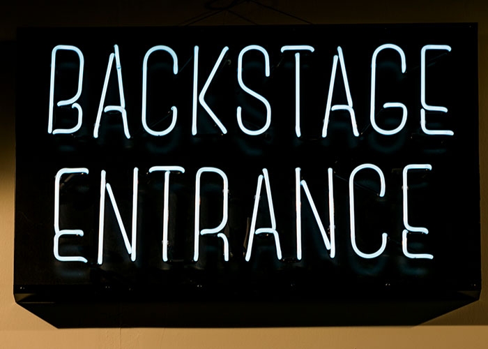 Sign that says Backstage Entrance