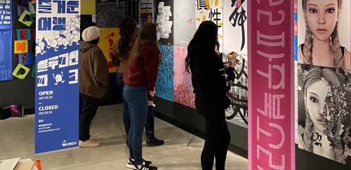 interior image of people looking at an art exhibit