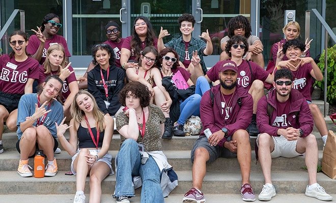 Group of orientation leaders sitting together on steps at New Student Orientation.