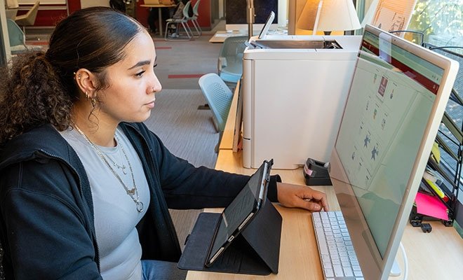 Student working on laptop and tablet