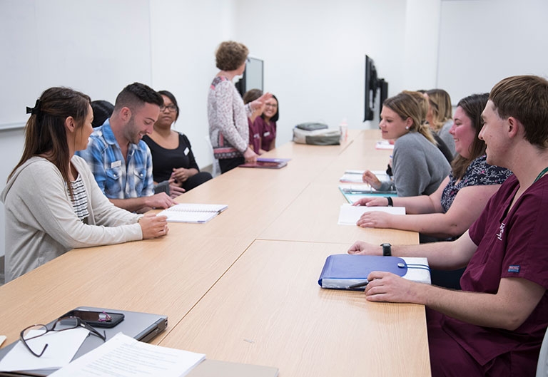 Nursing students and professor in a debriefing session