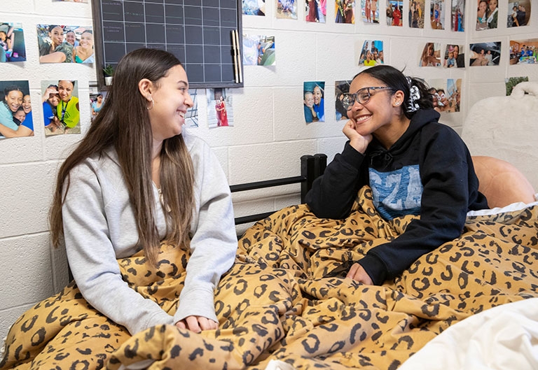 Students talking, laughing in dorm room