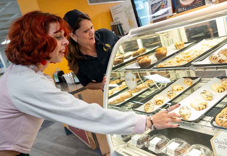 Students picking out pastry at The Beestro
