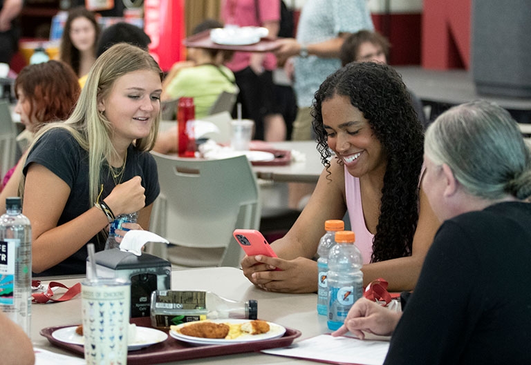 Students happily eating together in Donovan Dining Hall