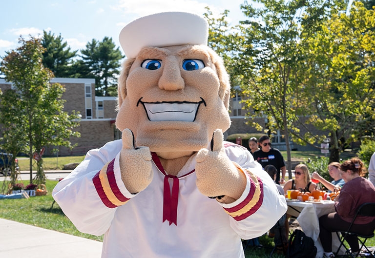anchorman mascot giving two thumbs up