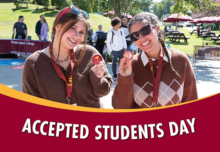 Smiling students holding "I love RIC" buttons