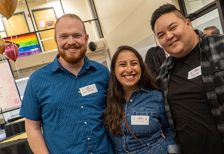 Alumni smiling together at an event