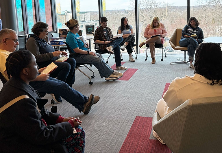 Rhode Island Writing Project participants sitting in a circle, together at an event