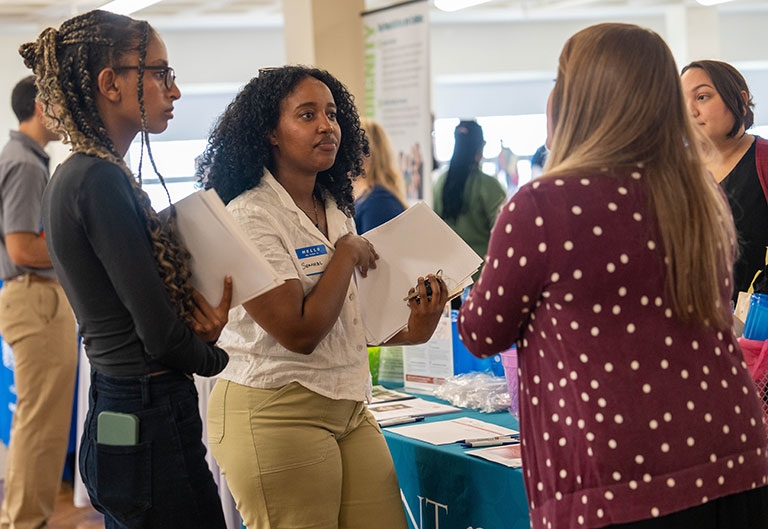 Students talking to employer at internship fair