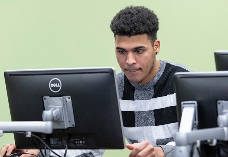 Student working at computer at the Workforce Development Hub in Central Falls, RI