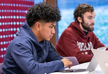 Two students working on laptops