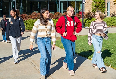 Students walking on campus quad walkway