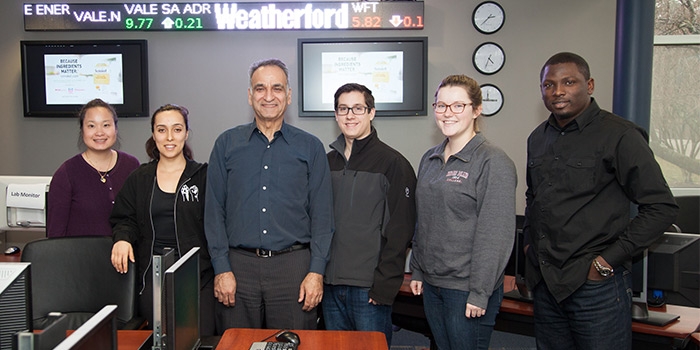 From left, RIC students Shuab Nouyi Yang and Kelli-Jo Vazquez; RIC Professor of Finance Abbas Kazemi; RIC students Justin Pereira, Michelle Asels and Adetokunbo Oni