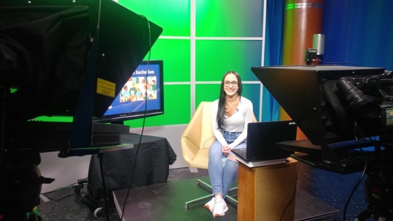 RIC Justice Studies student Lindsay Tahan seated in the RIC television studio