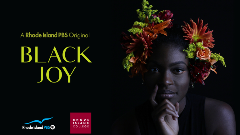 A black woman wears a flower headdress with the words "Black Joy" next two her