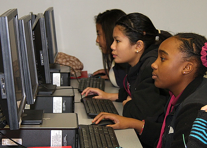 Young girls working at computer