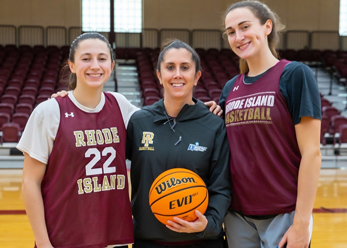 Two women's basketball players with coach