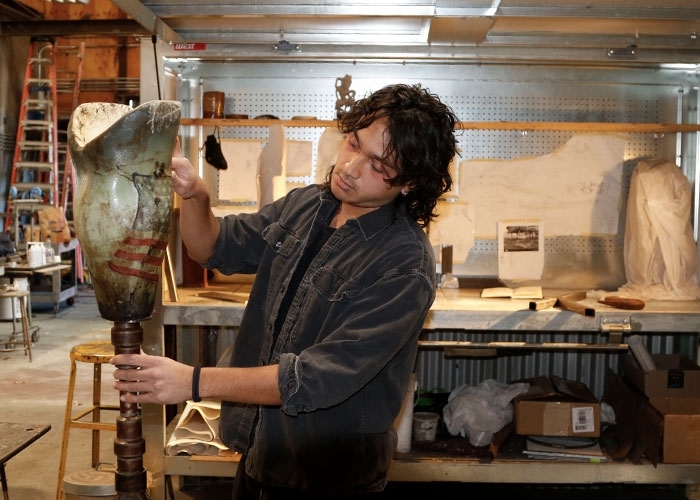 Alex Tum displays one of his sculptures in his workspace at The Steel Yard.