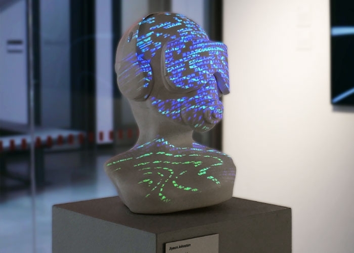 A stream of words with no context are projected across a human head that dons a virtual reality headset, a piece titled “Delusion” by Jiyeon Johnston