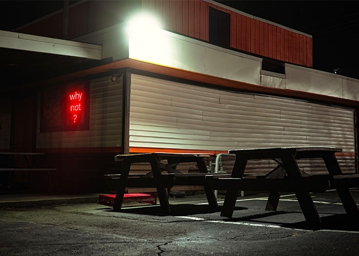 "A Dream," photograph by Simone Emerich of a building's exterior at night with a neon sign saying "why not?"
