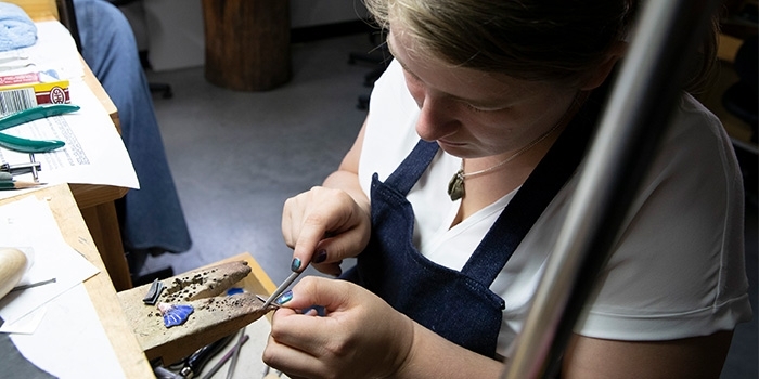 Greer Howard filing down metal for jewelry