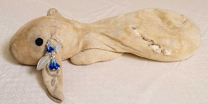 Stuffed animal wearing the jewelry of Greer Howard