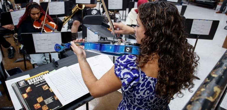 Lucini plays her blue violin along with concert band students. She also is adept at playing piano and percussion. 