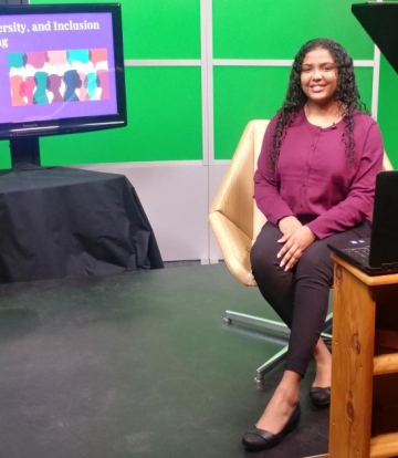 RIC Justice Studies student Kaisha Luciano seated in the RIC television studio