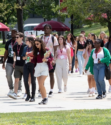 Cluster of students walking together outside at orientation