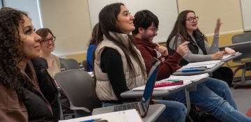 Happy math students at desks with supplies