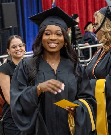 Graduate smiling in cap and gown