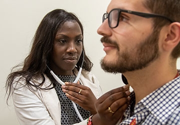 Nursing student listens to patient's breathing