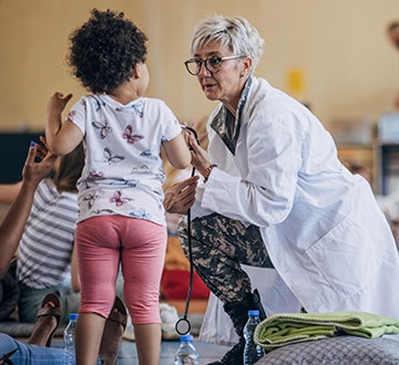 Nurse helping young child in a community setting