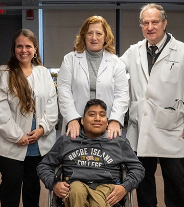 Health services clinicians with student in wheelchair