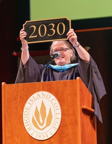 Vice President for Student Success Cindy Kozil shows off the Class of 2030 plaque at First-Year Convocation.
