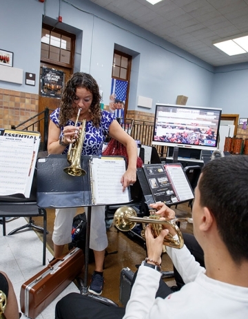Lucini guides her students by playing along on the trumpet.