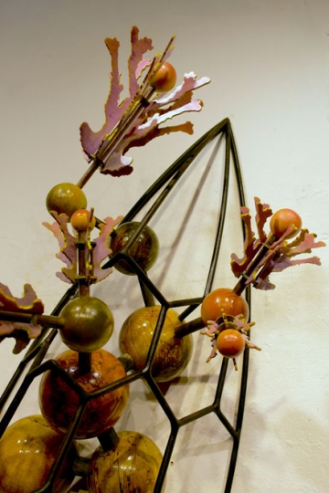 Close-up detail of a sculpture with organic flower components
