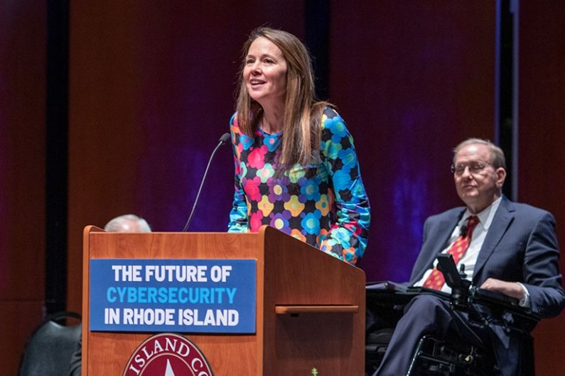Director of Cybersecurity and Infrastructure Security Agency (CISA) Jen Easterly at podium with U.S. Representative Jim Langevin