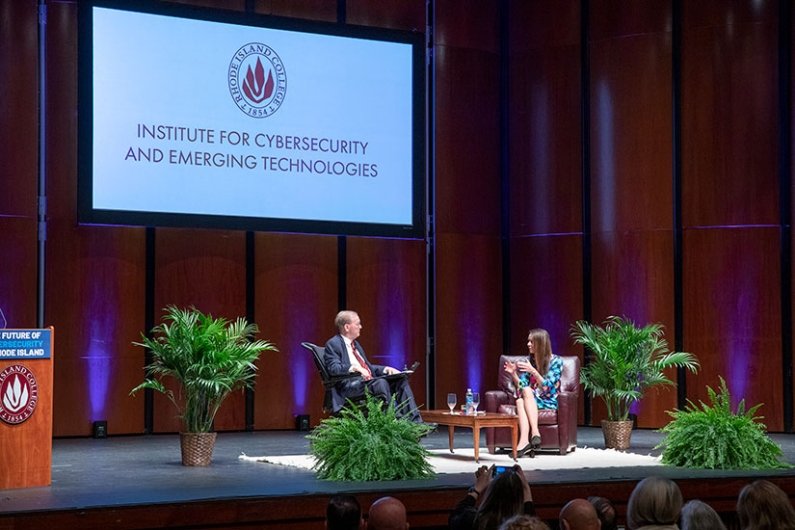 U.S. Representative Jim Langevin and Director of the Cybersecurity and Infrastructure Security Agency (CISA) Jen Easterly sit on stage for fireside chat during the launch of the Institute for Cybersecurity & Emerging Technologies 