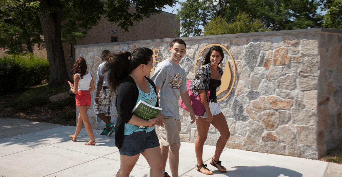 Three students walking outside on campus