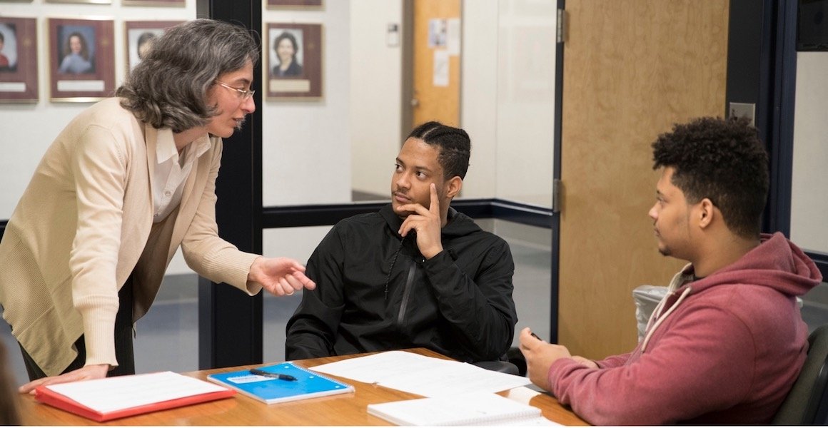 Professor in conversation with two students