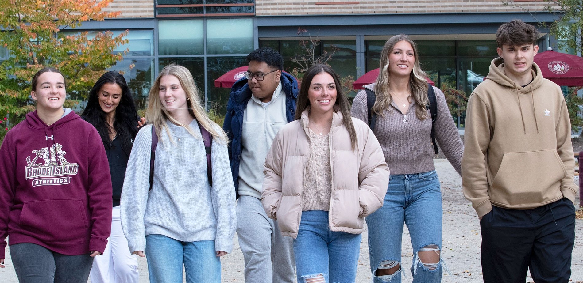 Students walking on quad together, smiling