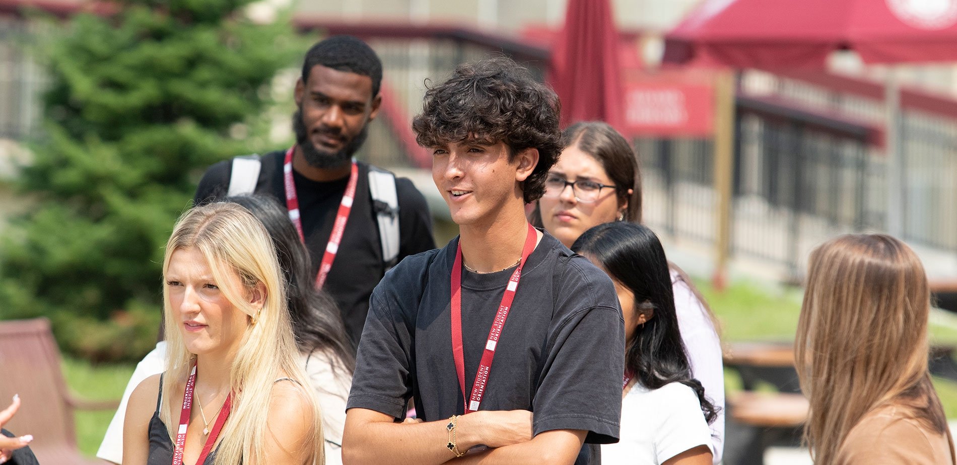 Students listening on campus at summer orientation
