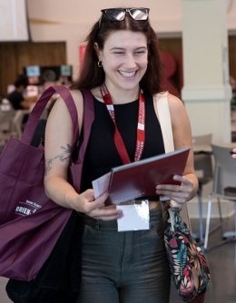 Excited RIC student holding materials