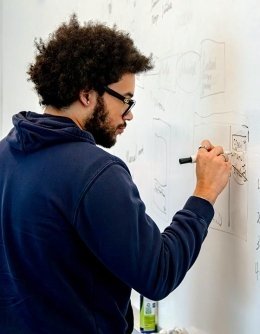 Hackathon winner writing on white board