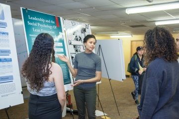 Student presenting a research poster