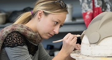 Art student works on a sculpture