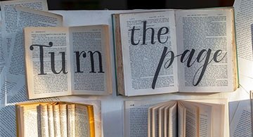Open books with text "turn the page"