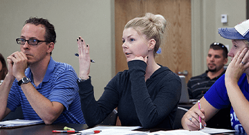 ​​Psychology students Andrew Kerbs, Nicole Cesaroni and Hillary Hewitt attend a psychology class at RIC. 