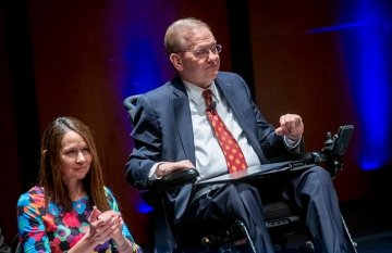 Jim Langevin and Jen Easterly on stage at the launch of the cybersecurity institute